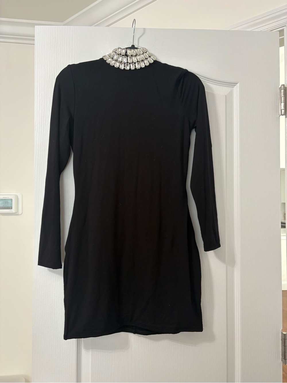 Naked wardrobe Black Long-Sleeve Mini Dress with Embellished Jewel collar.